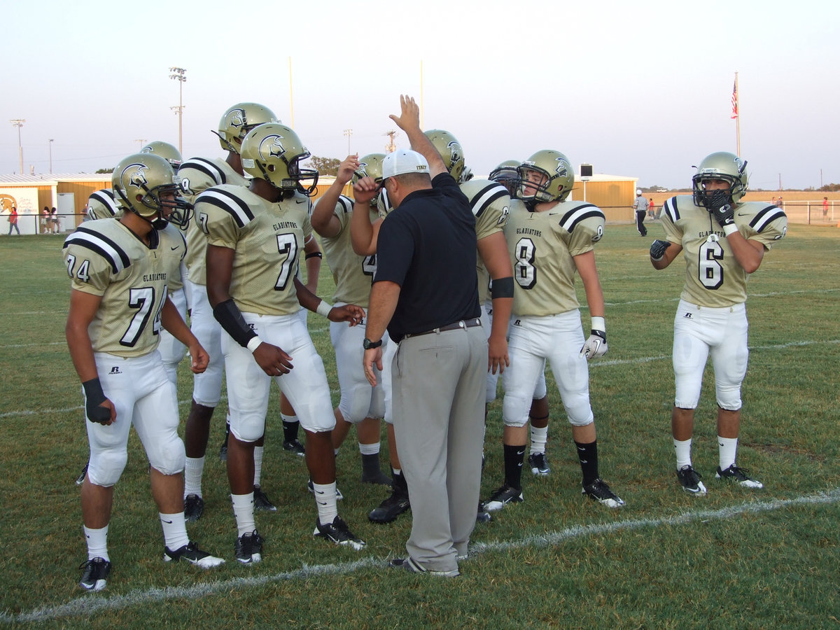 Image: Head coach Craig Bales gives his Gladiators a last minute pep talk before the game begins.