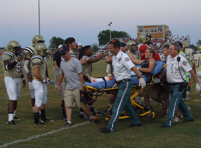 Image: Senior Brandon Souder was led off the field flanked by his teammates and friends.