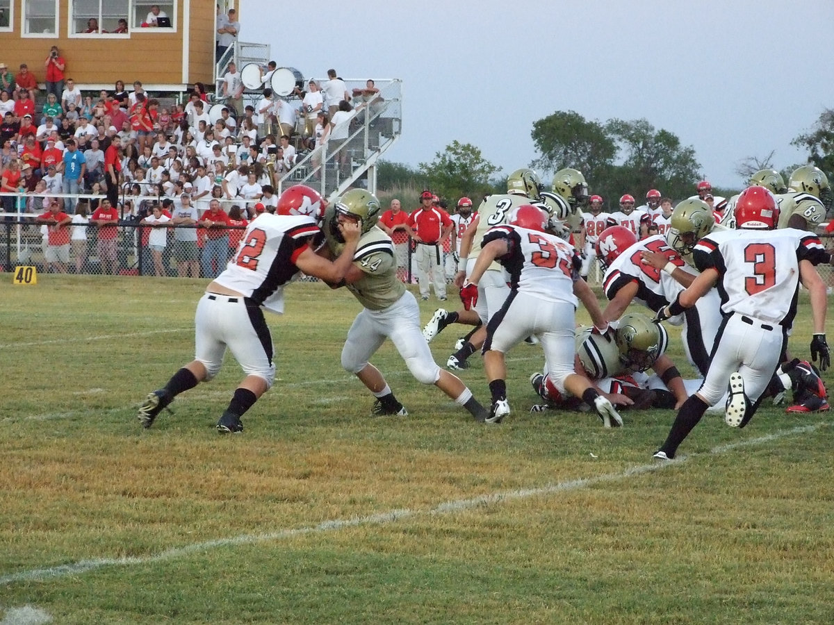 Image: Tight end Ethan Saxon(44) and the rest of the Gladiator line help Ryheem Walker find daylight.