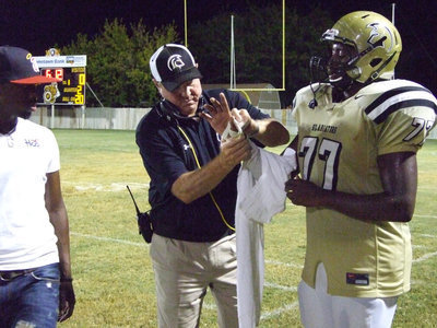 Image: Larry Mayberry, Jr. needs a little help from Coach Randy Parks.