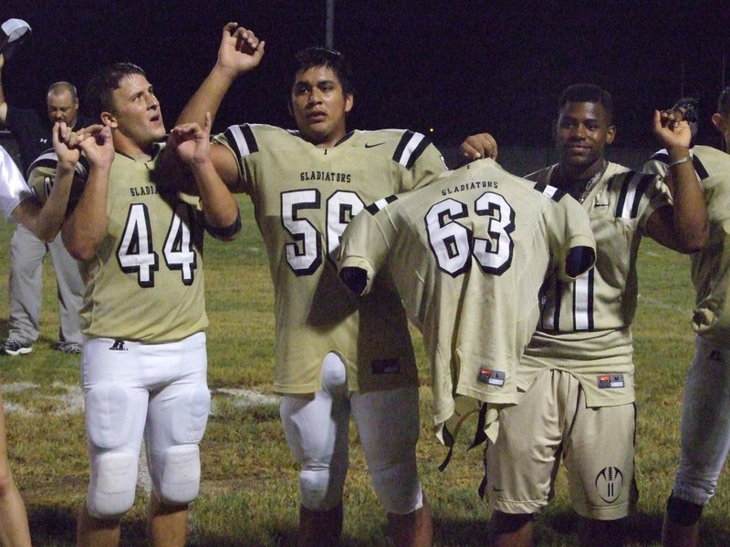 Image: The Gladiators sing their school song as they honor senior #63 Brandon Souder.