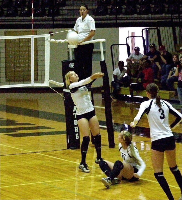 Image: Megan Richards(7) back sets while teammates Madison Washington(10) and Kaitlyn Rossa(3) hustle back into the play.