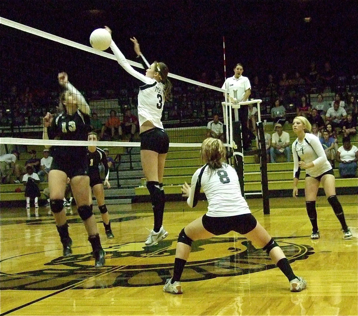 Image: Kaitlyn Rossa(3), Bailey Bumpus(8) and Megan Richards(7) protect their side of the center line.