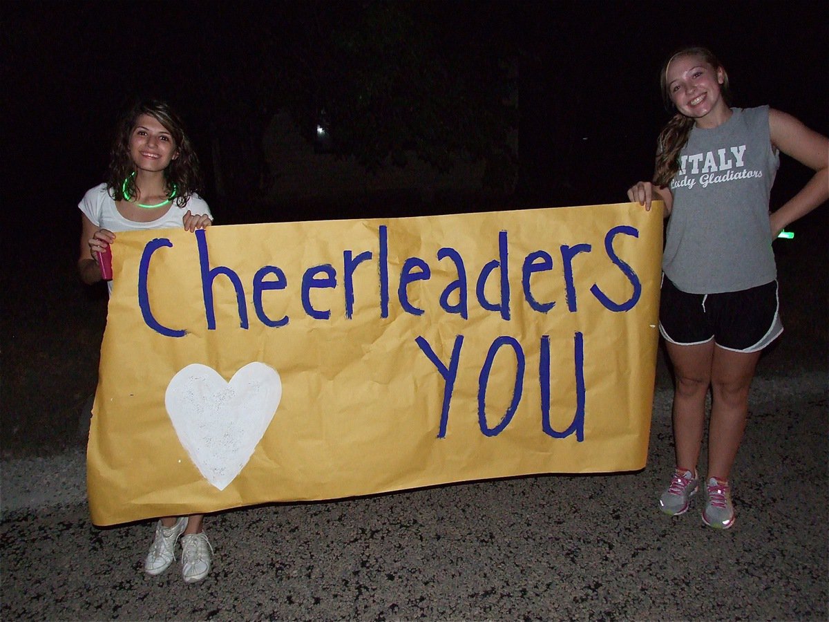 Image: Beverly Barnhart and Jaclynn Lewis greet Brandon with a sign and a smile.