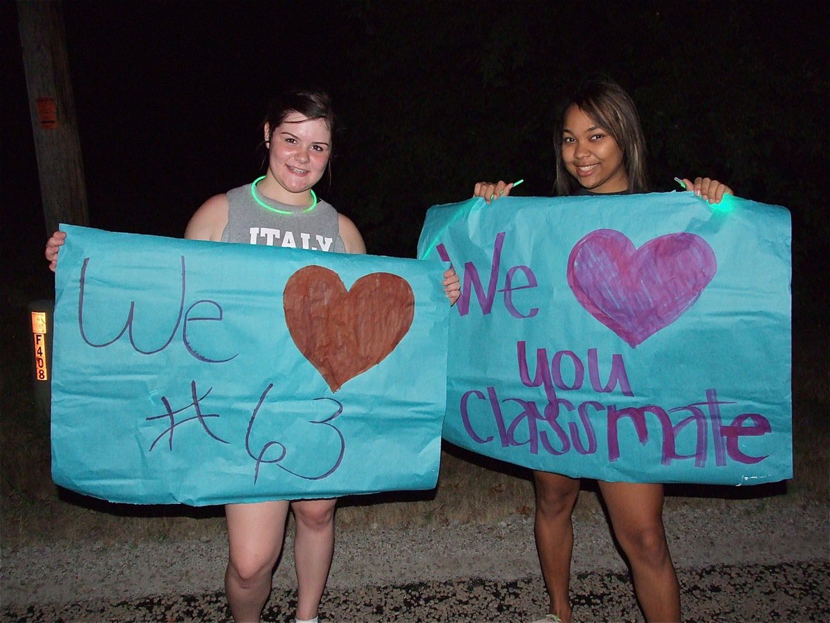 Image: Bailey DeBorde and Destani Anderson help line the street to Brandon’s house with love.