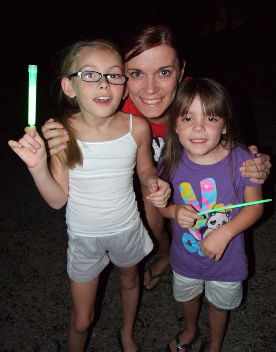 Image: Jenna Chambers and her two daughters, Madelyn and Morgan, help the community welcome home Brandon.