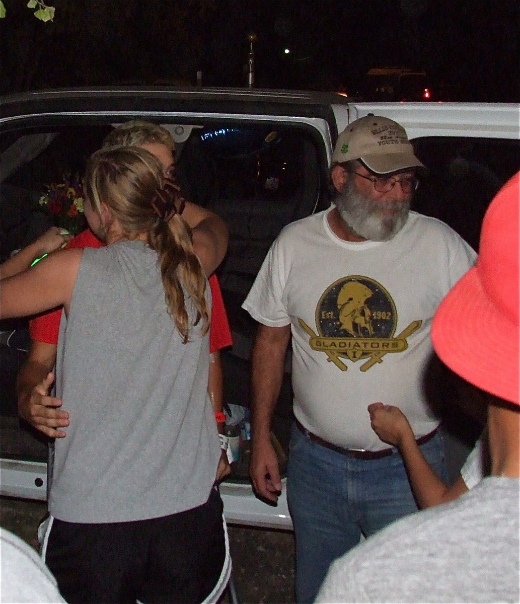 Image: Brandon Souder and his father Mark receive hugs from the community once they made it home from the hospital.