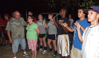 Image: Everyone participates in singing the school song outside the Souder home.