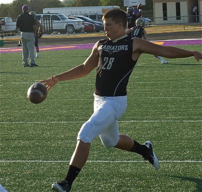 Image: Kyle Jackson(28) practices punting before the game and later boots a 74-yard punt against Mart.