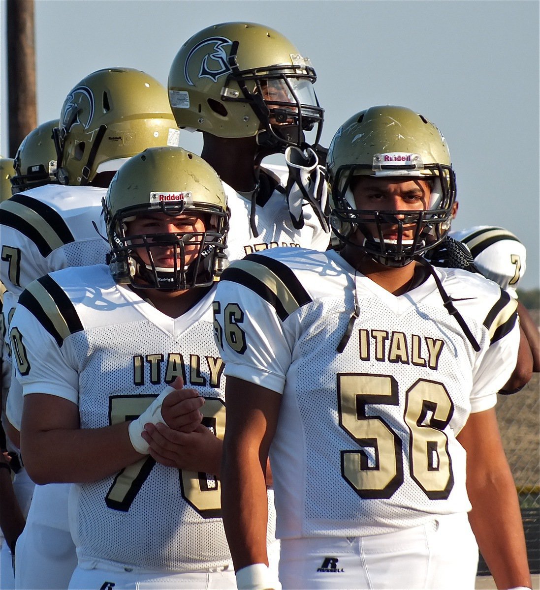 Image: Peering thru their masks as if looking thru sniper scopes on rifles, Gladiators Devonta Simmons(9), Isaac Medrano(70) and Omar Estrada(56) get ready to hunt down the Panthers.