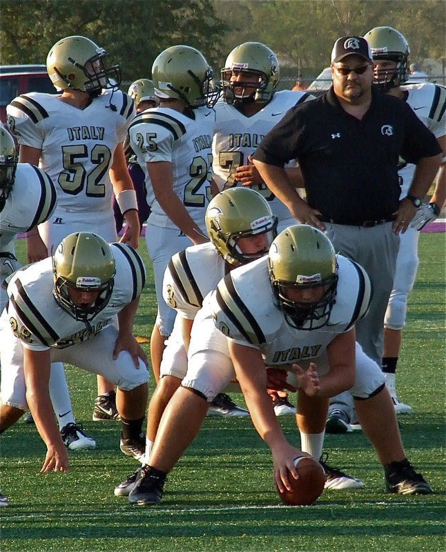 Image: Coach Craig Bales studies the progress of sophomore center Zain Byers(50) who was moved up from JV to try and fill the cleats of senior center Brandon Souder who is out for the season.