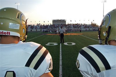 Image: Ethan Saxon(44) and Hayden Woods(8) stare down midfield toward the coin toss.