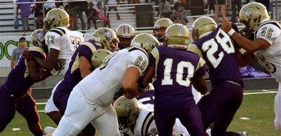 Image: Italy’s Larry Mayberry, Jr.(77), Kevin Roldan(60), Adrian Reed(64) and Omar Estrada(56) help Kyle Jackson(28) dart thru the heart of the Panthers defense.