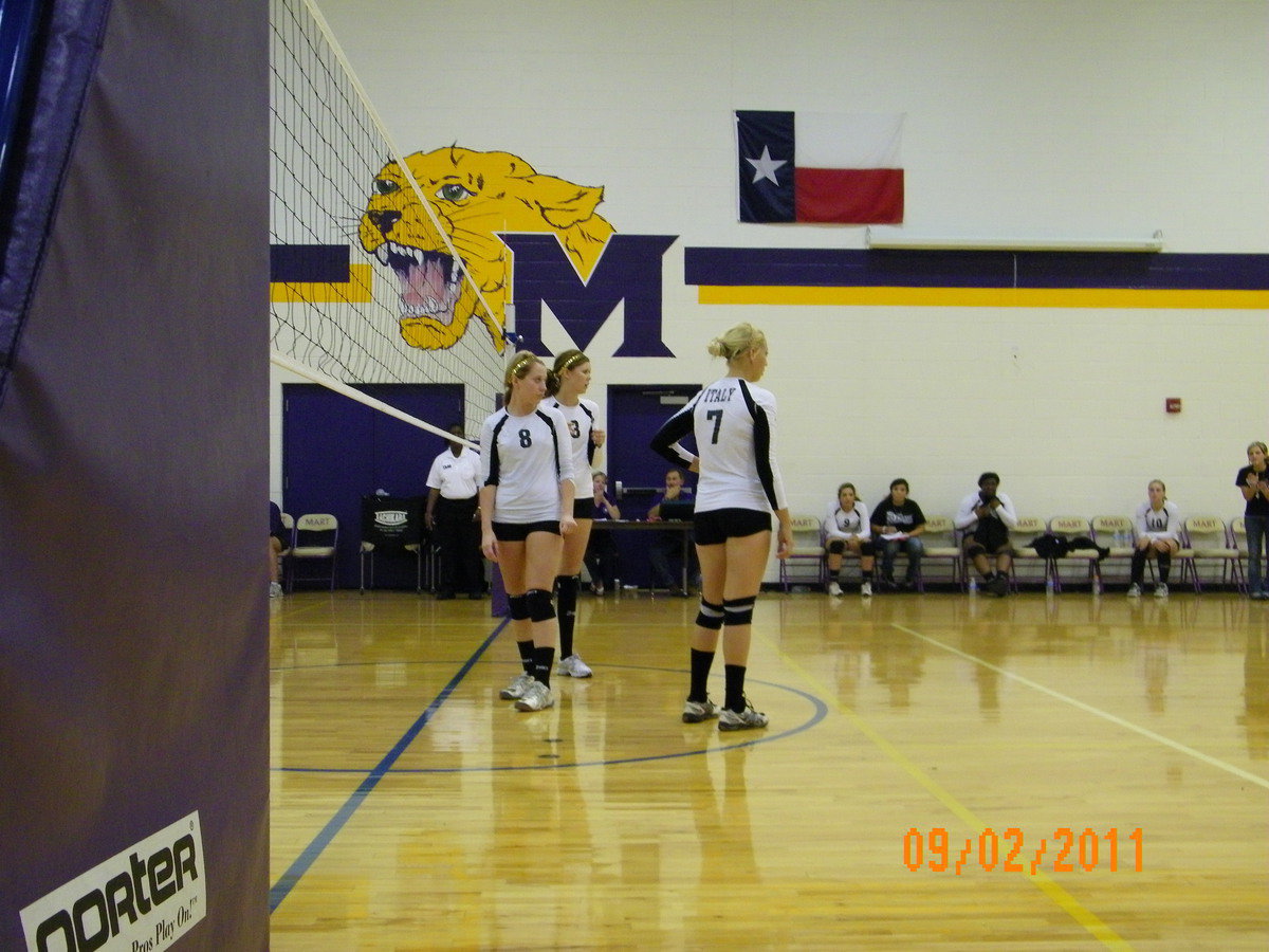 Image: Seniors Bailey Bumpus(8), Kaitlyn Rossa (3) and Megan Richards(7) await the serve of one of their teammates.