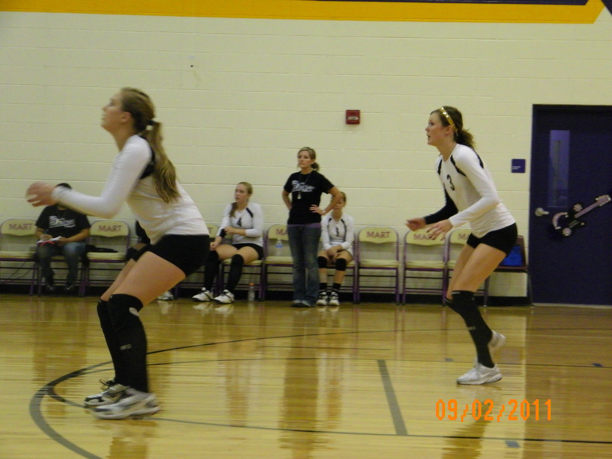 Image: Madison Washington (freshman) and Kaitlyn Rossa (senior) react to the ball.