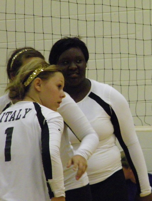 Image: Eubank, Alyssa Richards (junior) and Jimesha Reed (senior) prepare to get into position after the serve.