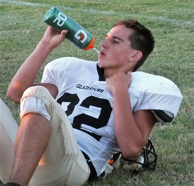 Image: Cody Medrano(32) takes a much needed water break at halftime with the Italy JV only able to field eleven players for the game.