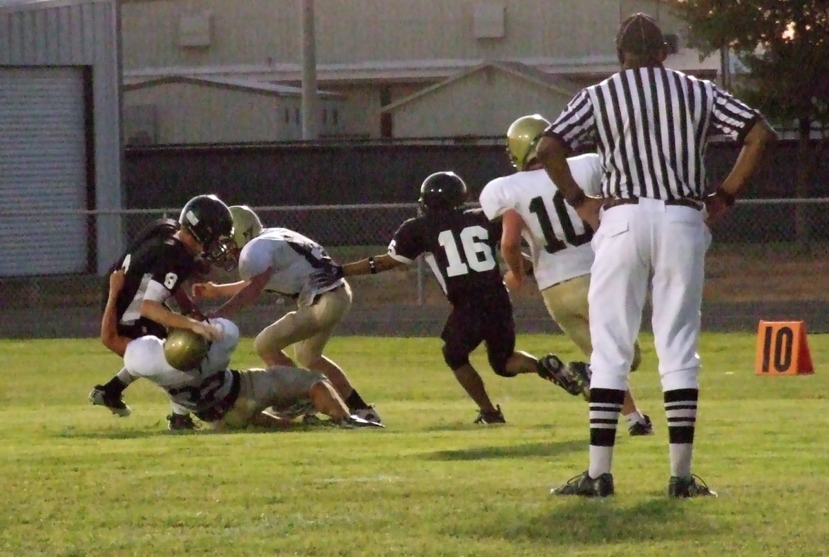 Image: Italy’s Cody Medrano(32) and John Escamilla(88) capture a Bulldog for a loss with teammate Kyle Fortenberry(10) rushing in to make certain.