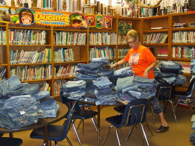 Image: Miss Wimbish (library worker) is trying to figure out the best way to sort all of these blue jeans.