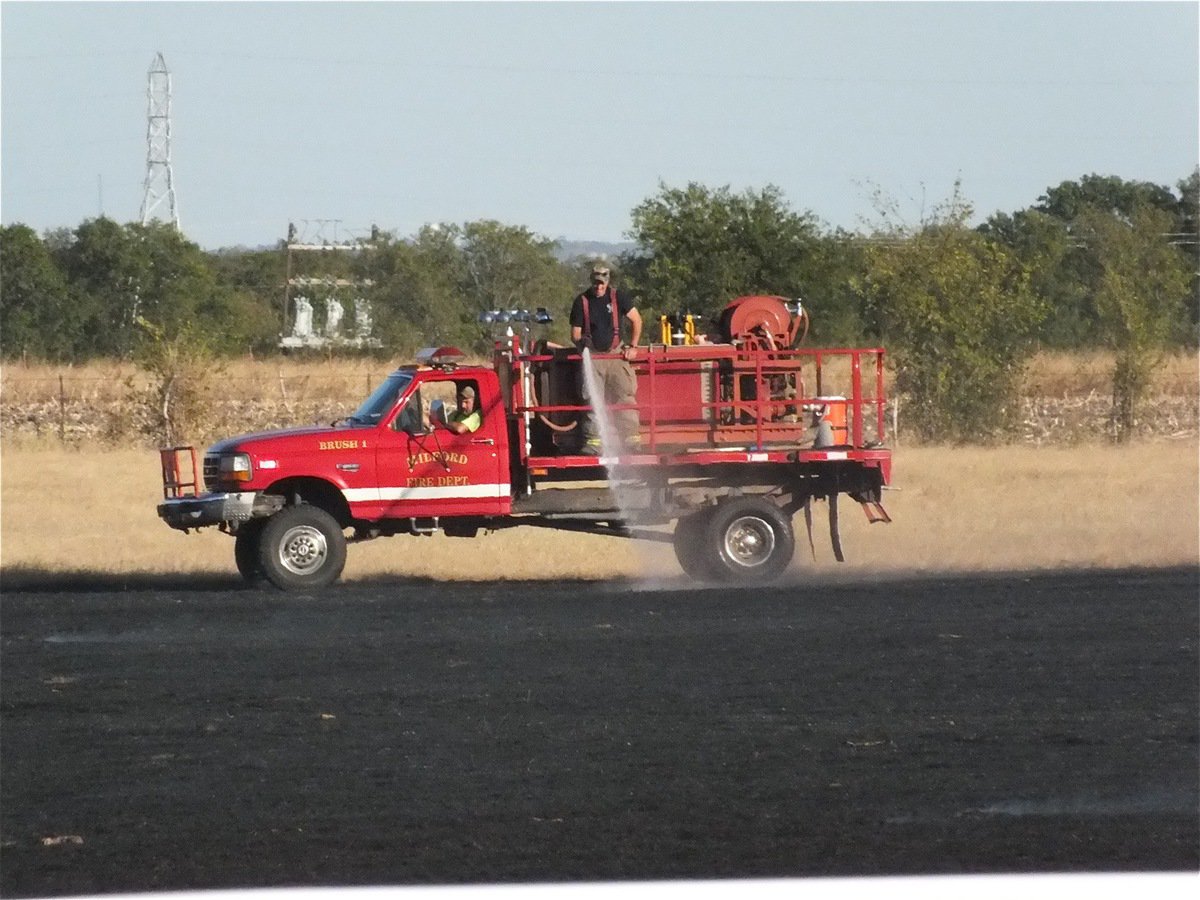 Image: The Milford Volunteer Fire Department hoses down hot spots.