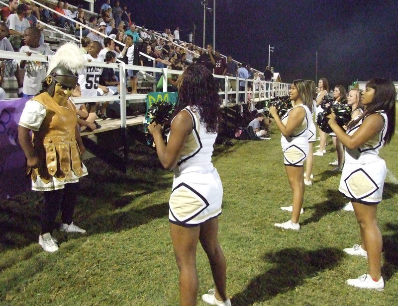 Image: Gladiator mascot, Sa’Kendra Norood, leads the varsity cheerleaders in a cheer.