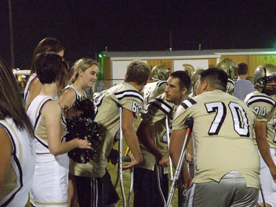 Image: The IHS Cheerleaders keep Brandon Souder(63), Tony Wooldridge(6) and Isaac Medrano’s(70) spirits up as they players recover from injury.