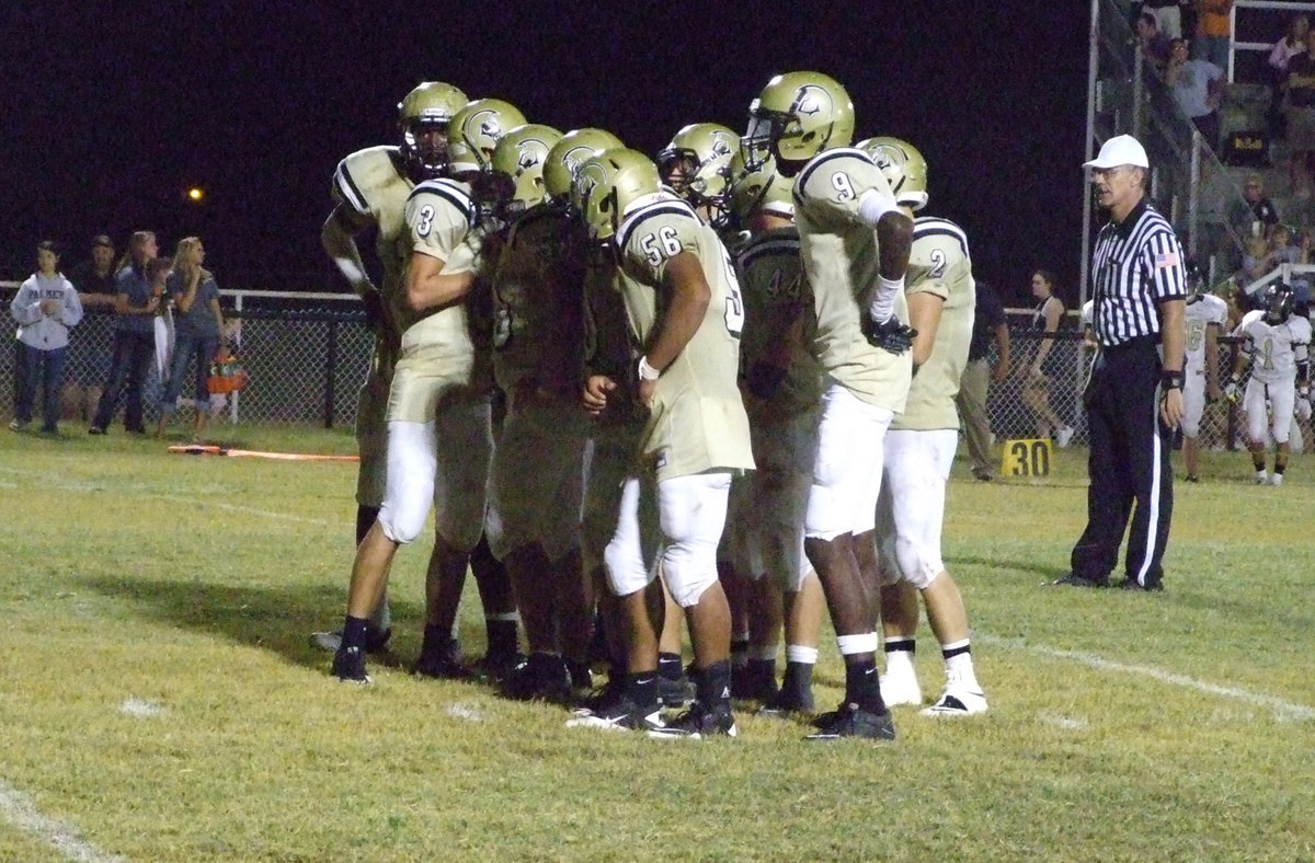 Image: What’s the play? Jase Holden(3) huddles the offense.