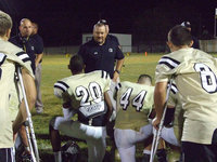 Image: Coach Bales gives the guys a pep talk after the game.