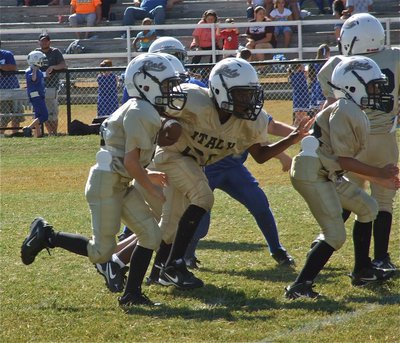 Image: Preston Rasco(9) and Michael Gonzalez(22) lead the way for teammate Ricky Pendleton(21) who carries the ball for a big gain during the B-Team game.