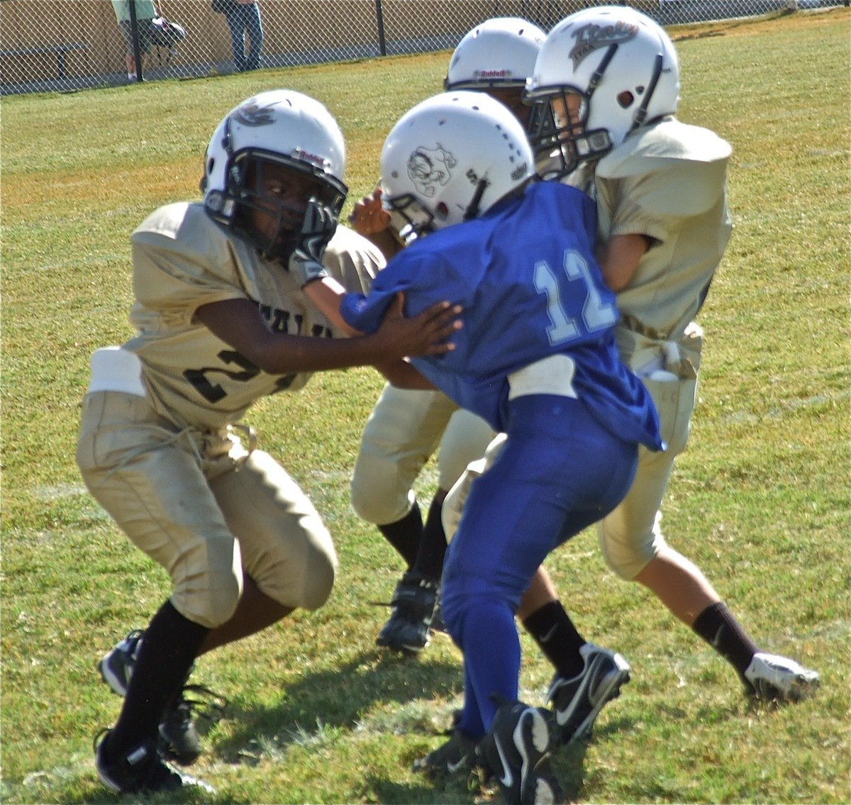 Image: Ricky Pendleton(21) gets help from fellow defenders Parker Richters and Jayden Barr as the trio tries to tackle a Bulldog runner.