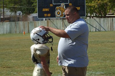 Image: B-Team assistant coach Andy Saxon has some positive words with hard hitting tackler Bryce DeBorde(44). 