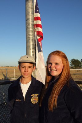 Image: Marcus Surles and Katie Byers represent the Italy FFA and handle the duties of raising the flags as part of the pre-game ceremony at Willis Field.