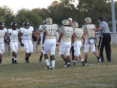 Image: Italy captains Larry Mayberry, Jr.(77), Omar Estrada(56), Ethan Saxon(44) and Jase Holden(3) meet the Palmer Bulldog captains at midfield.