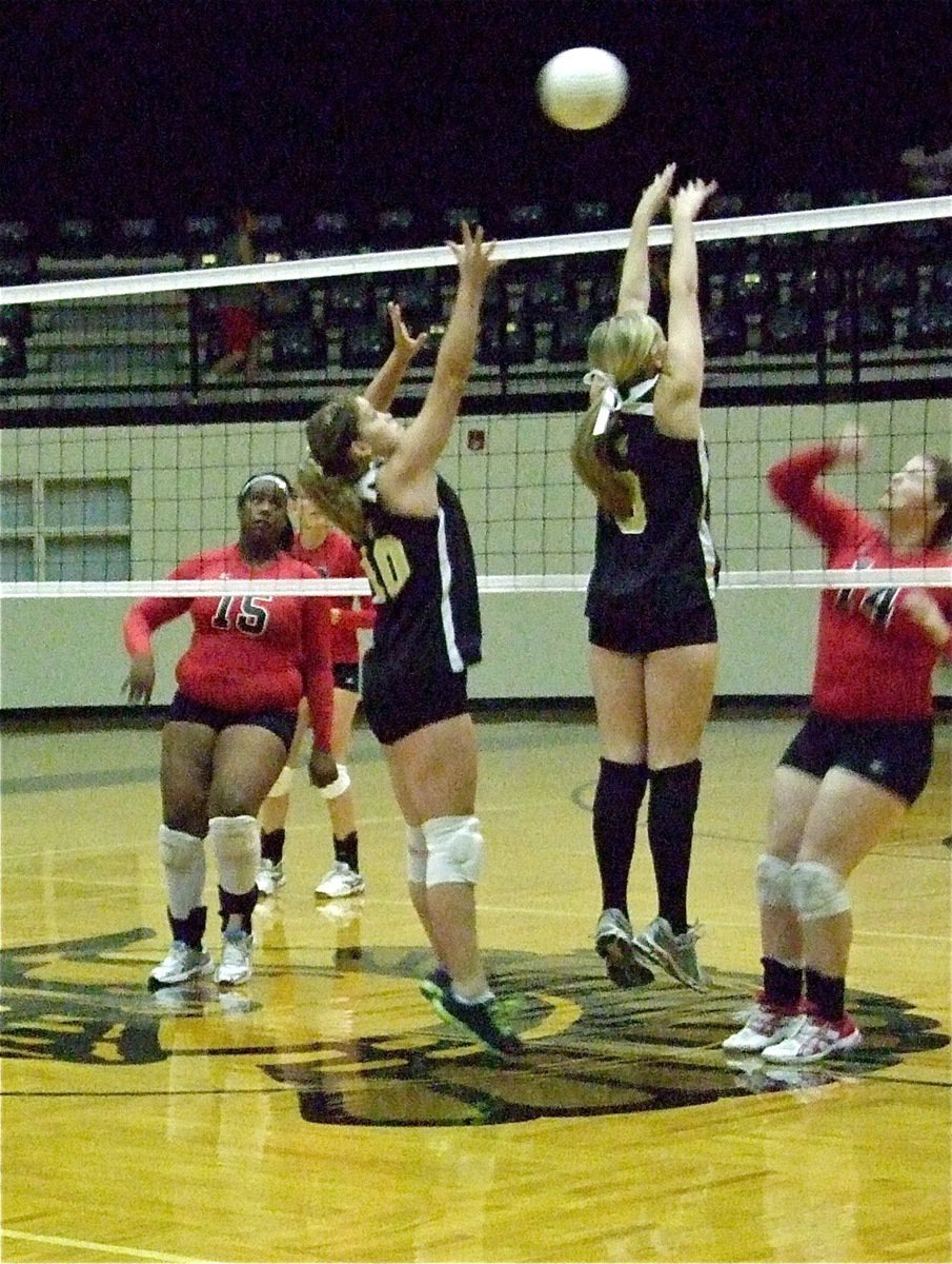 Image: Paige Westbrook and Kelsey Nelson try to execute a block at the net.