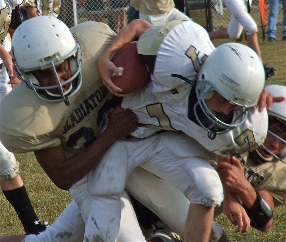 Image: Playing angry are Jaray Anderson(32) and Joseph Celis(6) who combine to tackle a Jaguar runner.