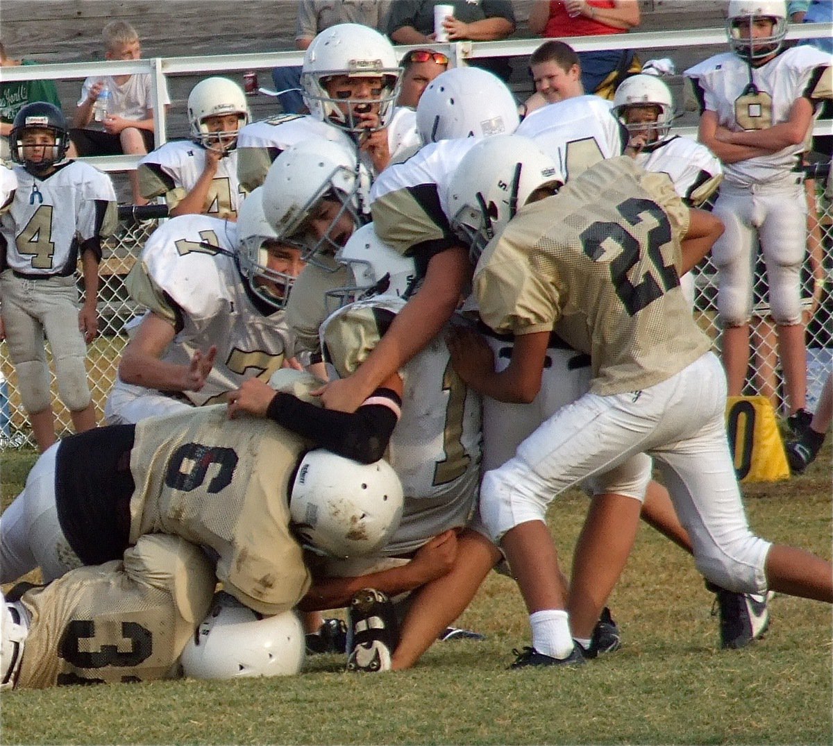 Image: Jaray Anderson(32), Joseph Celis(6) and Fabian Cortez(22) do whatever it takes to stop Hubbard.