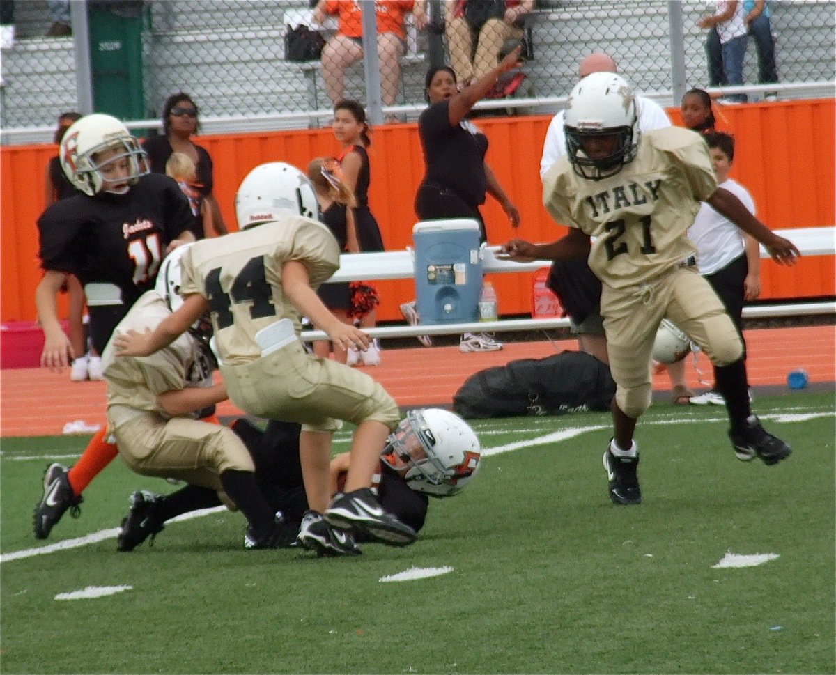 Image: IYAA B-Team (3rd &amp; 4th) defenders Ty Cash(24), Jayden Saxon(44) and Ricky Pendleton(21) keep a Ferris runner from reaching the endzone. 