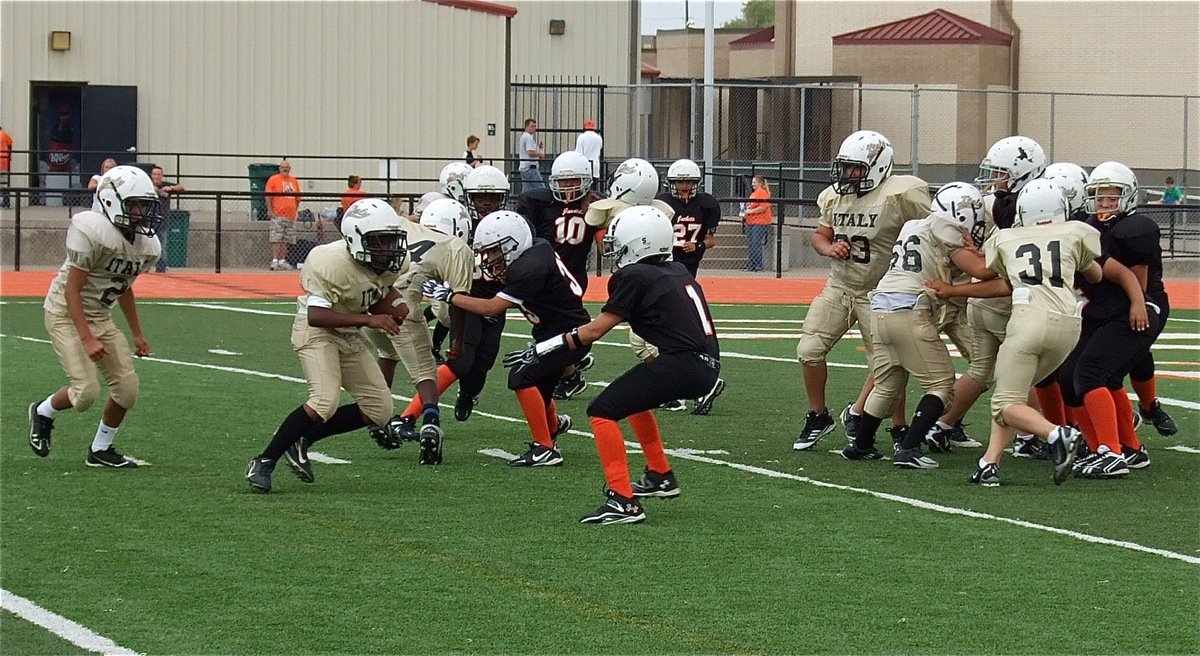 Image: Taron Smith(34) searches for a crease behind his offensive line.