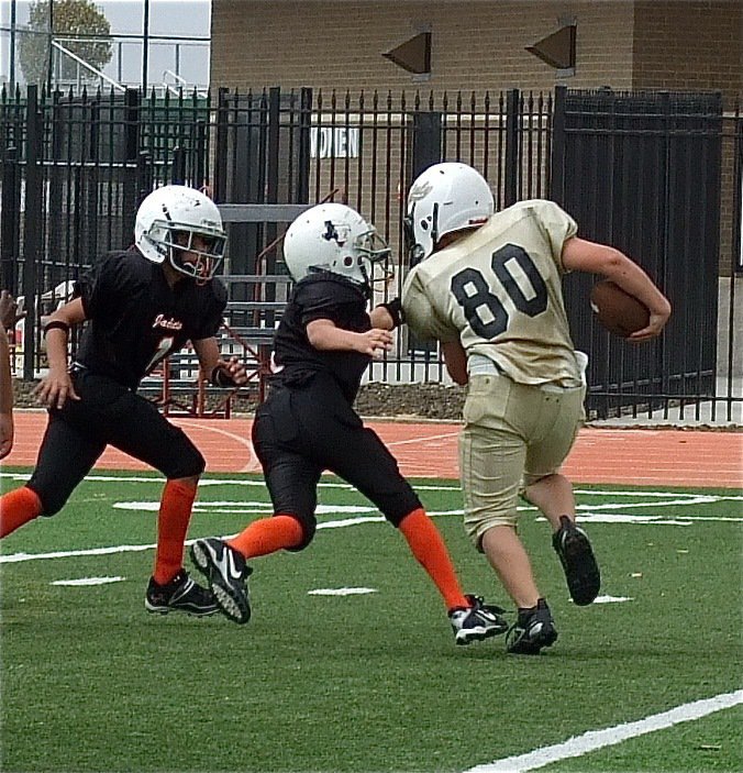 Image: Isaac Salcido(80) takes on a couple of Yellow Jacket defenders.