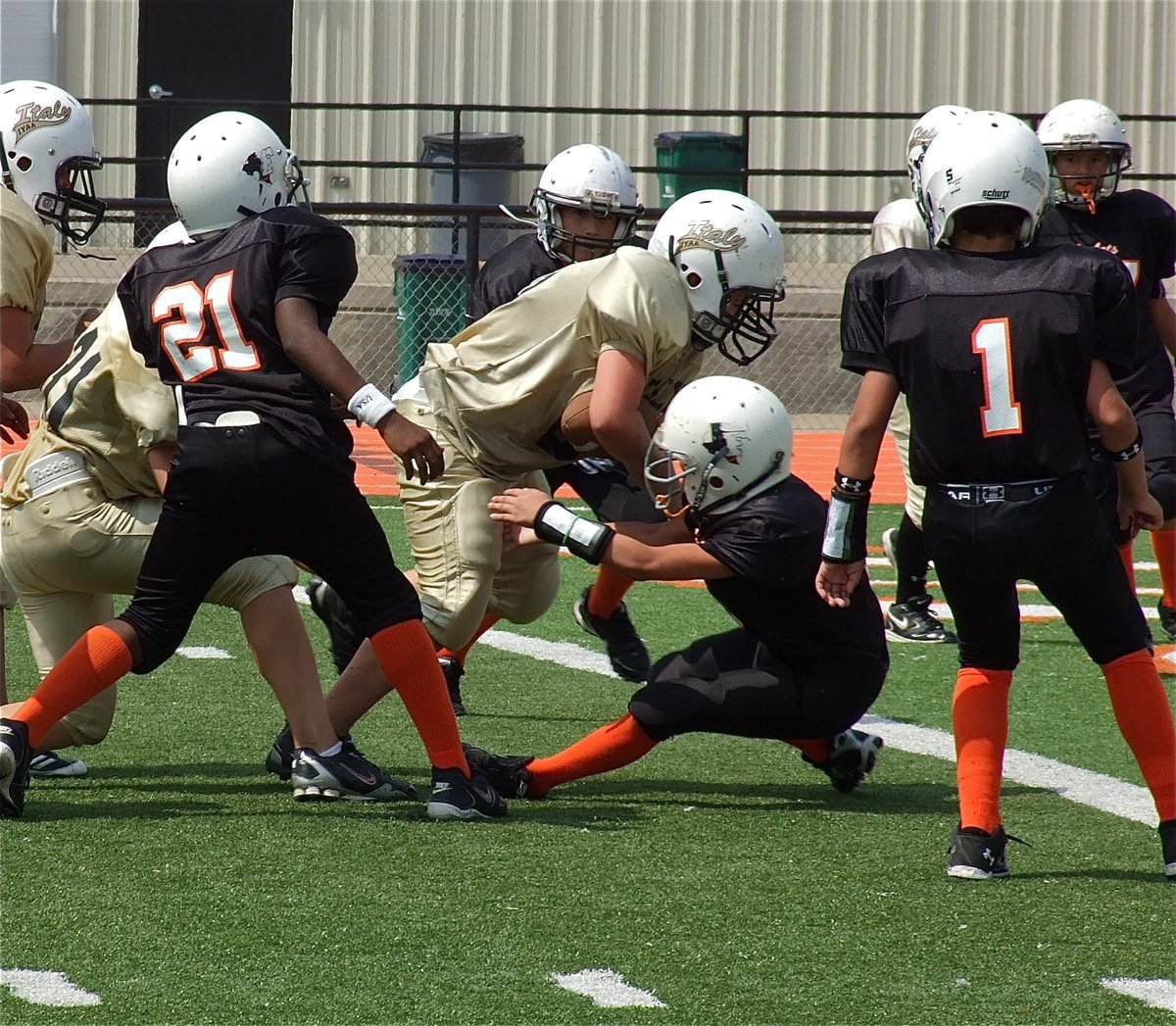 Image: Isaac Salcido(80) powers his way over a Ferris defender to score a 1-point conversion to give the IYAA A-Team a 9-0 lead.