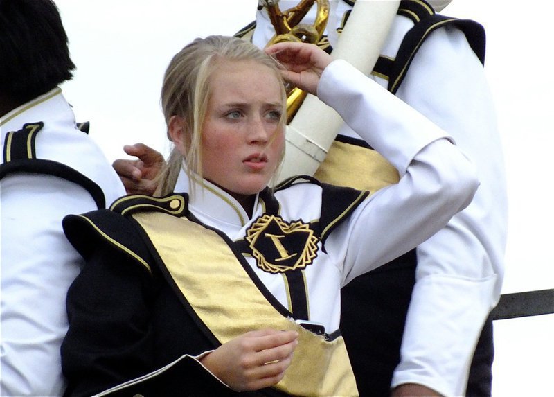 Image: Instrument, check. Hair clip, check. Game face, check. Gladiator Regiment Marching Band member Hannah Washington gets set for the game.