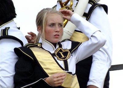 Image: Instrument, check. Hair clip, check. Game face, check. Gladiator Regiment Marching Band member Hannah Washington gets set for the game.