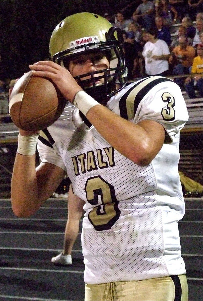 Image: Gladiator quarterback Jase Holden(3) warms up his passing arm before the game. Holden would later complete a 58-yard touchdown pass to teammate Ethan Saxon.