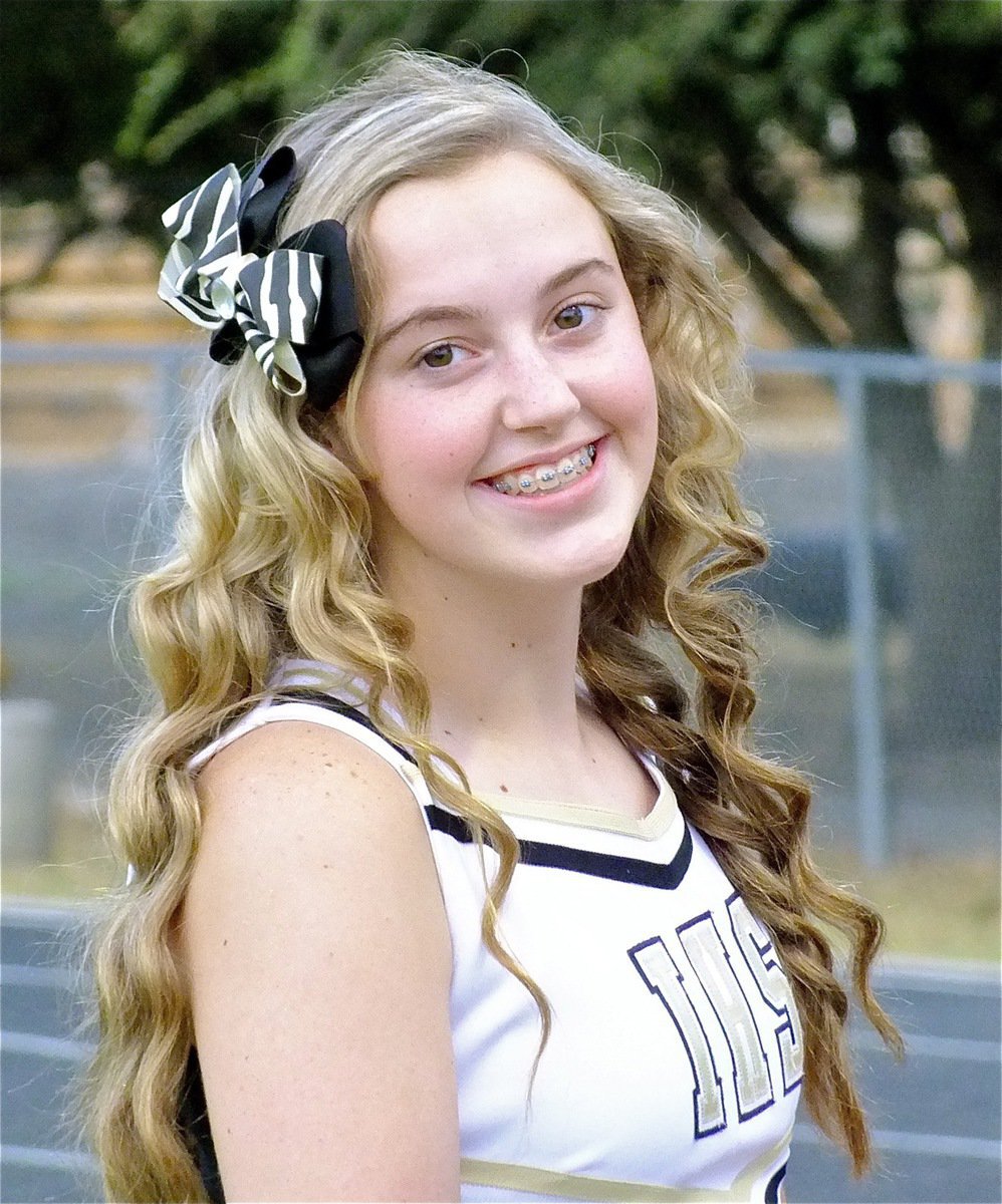 Image: Hair we go! IHS Cheerleader Kelsey Nelson gets ready to cheer on the Gladiators.