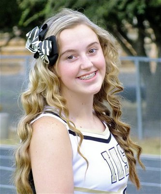 Image: Hair we go! IHS Cheerleader Kelsey Nelson gets ready to cheer on the Gladiators.