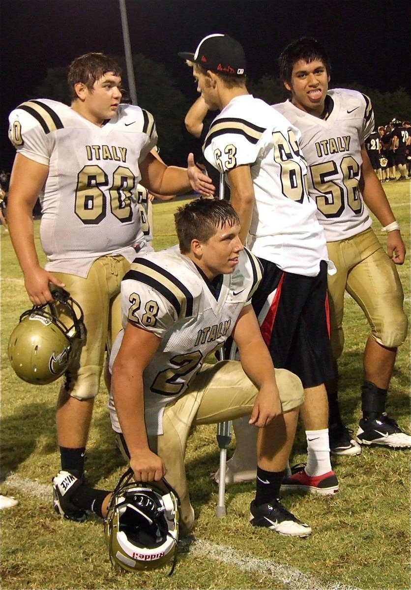 Image: Senior Brandon Souder(63) shakes the hands of his teammates Kevin Roldan(60), Omar Estrada(56) and Kyle Jackson(28) after getting the win against Hubbard.