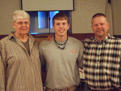 Image: New firefighter Justin Buchanan with grandmother, Linda and dad, Mark.
