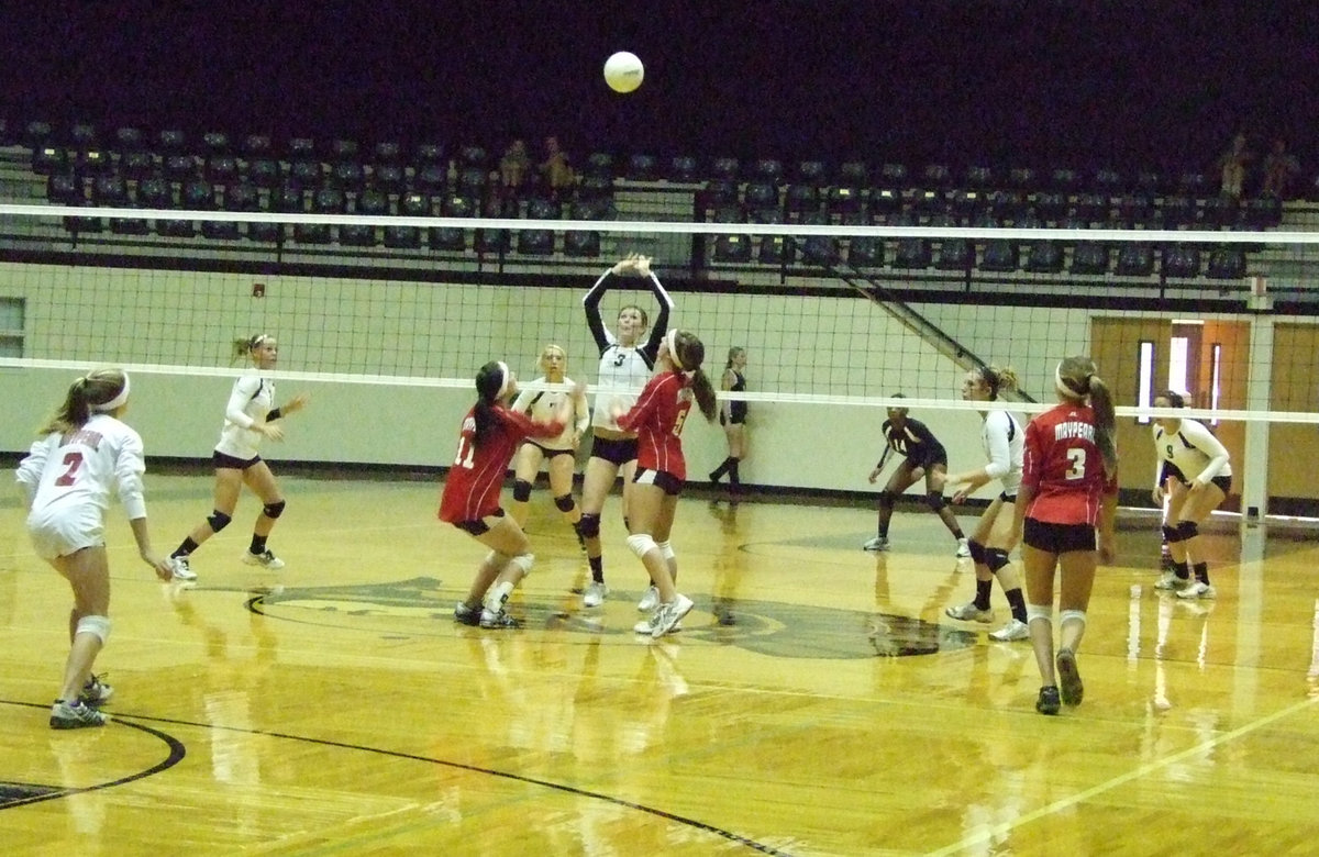 Image: 
    	Kaitlyn Rossa defends the net against the Lady Panthers.
    