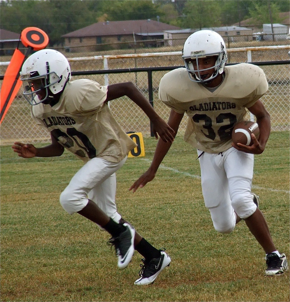 Image: Chasston King(20) lead blocks for Jaray Anderson(32).