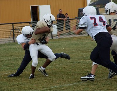 Image: Jaray Anderson(32) is unable to escape the Mustang defense.